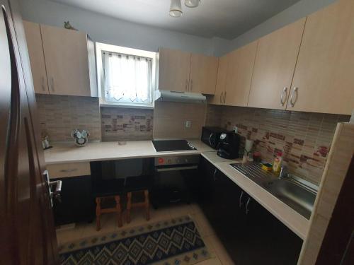 a small kitchen with a sink and a stove at Apartament Centru Vatra in Vatra Dornei