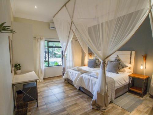 a bedroom with a bed with a canopy at 701 Victoria Falls in Victoria Falls