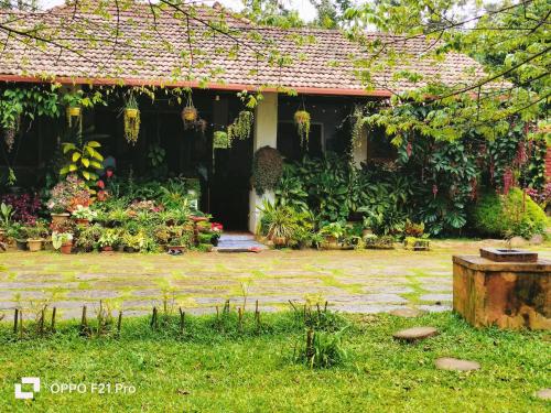 a house with a bunch of flowers in the yard at Edgestay in Mudigere