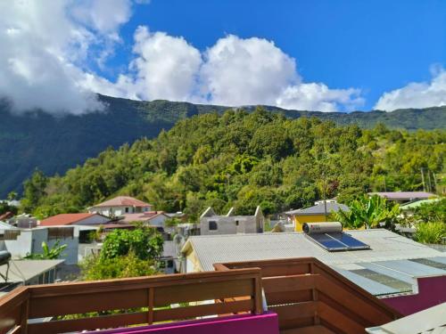 a view of a city with mountains in the background at Chez Claudia in Salazie