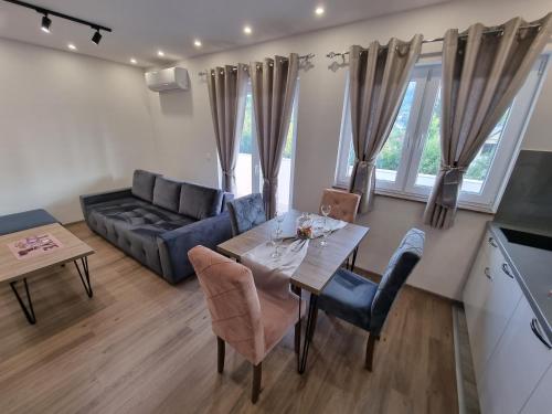 a living room with a table and a couch at Villa Park Ravne in Visoko