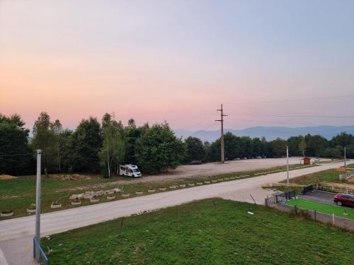 a road with a van driving down a road at Villa Park Ravne in Visoko
