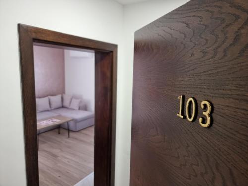 a door to a living room with a couch at Villa Park Ravne in Visoko