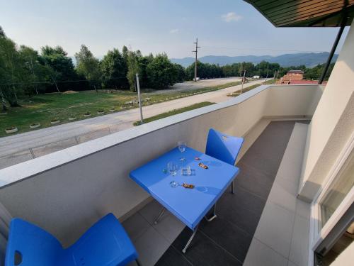 a blue table and chairs on a balcony at Villa Park Ravne in Visoko