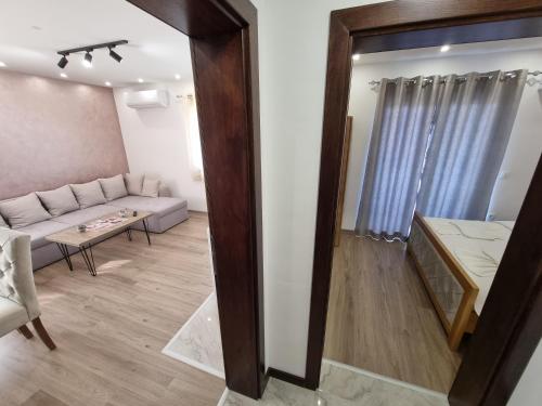 a living room with a couch and a mirror at Villa Park Ravne in Visoko
