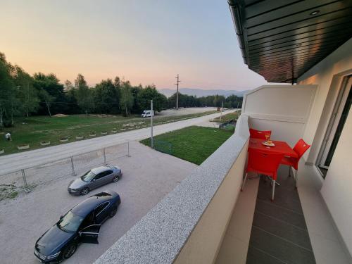a balcony with a car parked on a street at Villa Park Ravne in Visoko