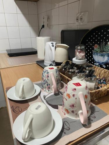 a kitchen counter with white and pink tea pots and plates at Michel FREE PARKING in Vranje