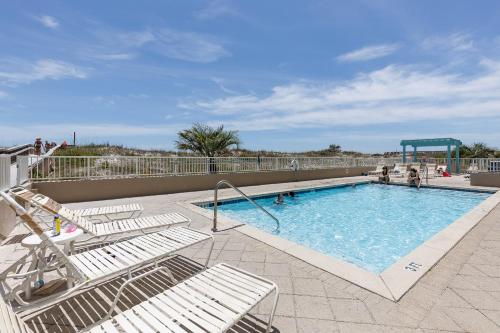 a swimming pool with chairs and a slide at GD 411:THIS 3 BDRM IS TOP-OF-THE-LINE! THE UPGRADES ARE ASTONISHING in Fort Walton Beach
