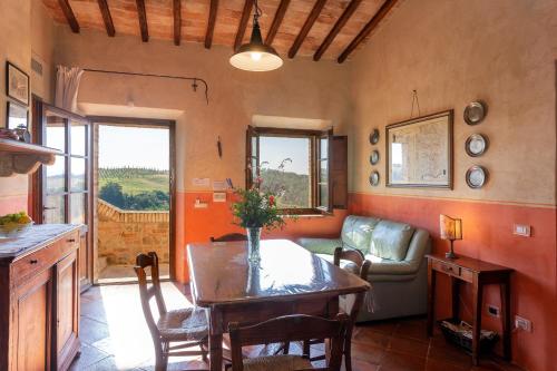 a living room with a table and a couch at Podere Cunina in Buonconvento