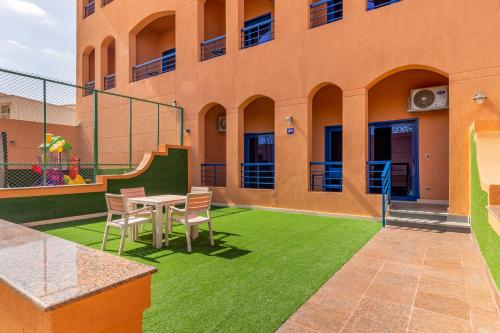 a patio with a table and chairs in front of a building at Royal Day Plaza Hotel in 6th Of October