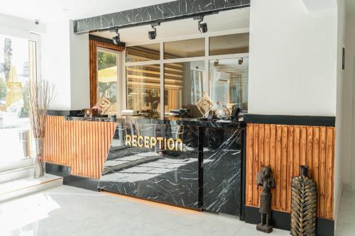 a restaurant with a black counter and a window at Far Life Hotel in Antalya