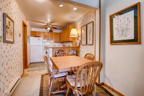 a kitchen and dining room with a wooden table and chairs at The Plaza Condominiums by Crested Butte Mountain Resort in Mount Crested Butte