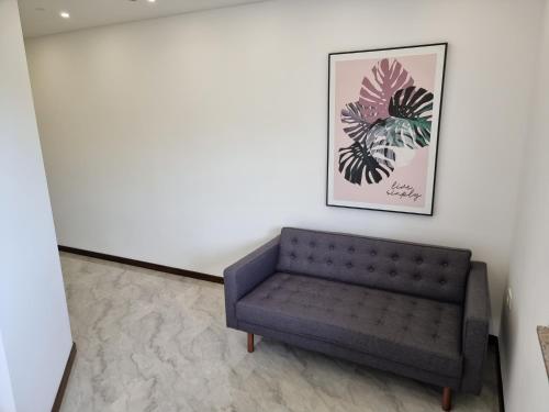 a couch in a room with a picture on the wall at Villa Park Ravne in Visoko