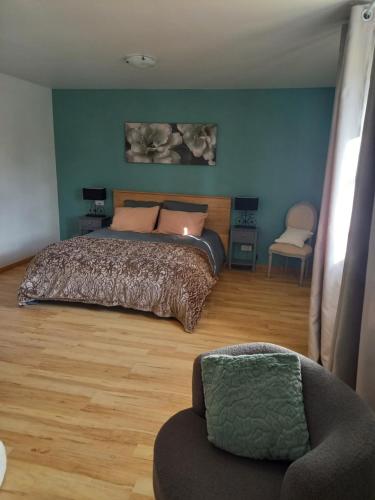 a bedroom with a bed and a chair at Alpagas de Barres in Sénaillac-Latronquière