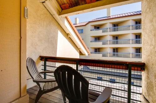 two chairs sitting on a balcony with a building at The Plaza Condominiums by Crested Butte Mountain Resort in Mount Crested Butte