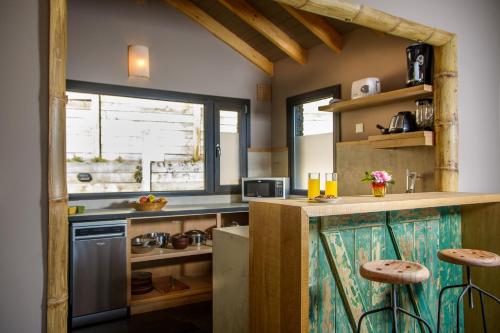 a kitchen with a counter with stools in it at Correntoso TownHouses in Villa La Angostura