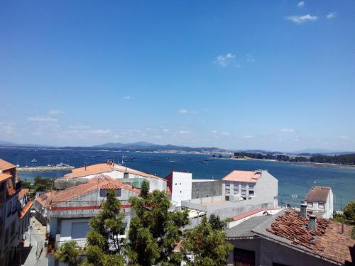 a view of the water from a city with buildings at Hotel Amandi in O Grove