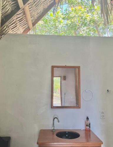 a bathroom with a sink and a mirror at Hausatins in Atins