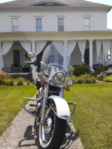 a motorcycle parked in front of a house at Queens Chamber w King Heavenly Bed at Nottingham Place in Wise in Wise