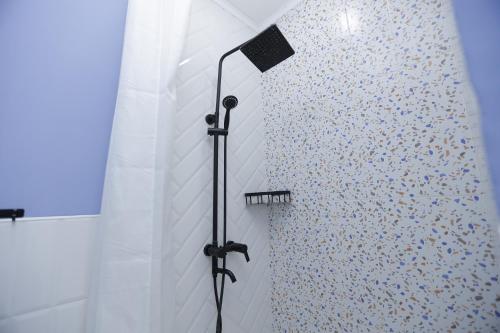 a shower with a shower head in a bathroom at Apart Hotel Bishkek in Bishkek