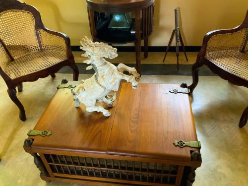 a wooden table with a rocking horse on top of it at Headman House Antique Villa - Ahangama in Ahangama
