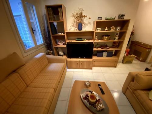 a living room with a couch and a table at Cute 2bdrm in Salonica Center in Thessaloniki