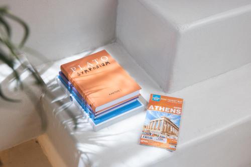 a stack of books sitting in a drawer next to a book at Gèa Athenian Suites in Athens