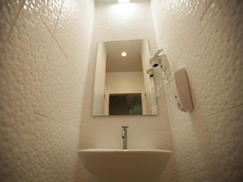 a bathroom with a sink and a mirror at Micro Hostel in Bangkok