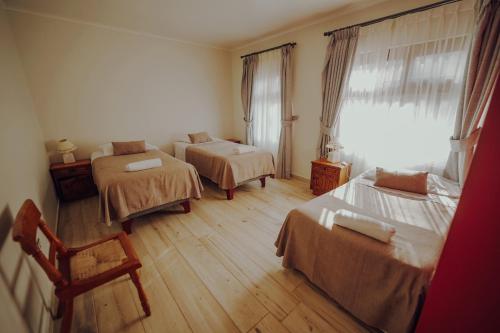 a room with two beds and a window at Hotel Naturaleza Vertientes de Elqui in El Molle