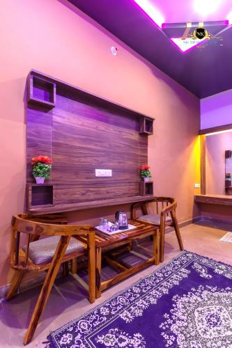 a living room with a bench and a large wall at NK Desert Camp Jaisalmer in Sām