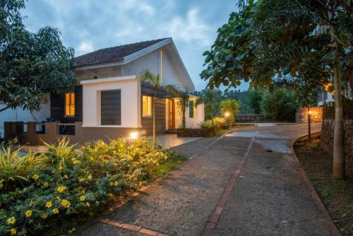 a house with a pathway in front of it at Dazzle Villa Resort in Kalpetta