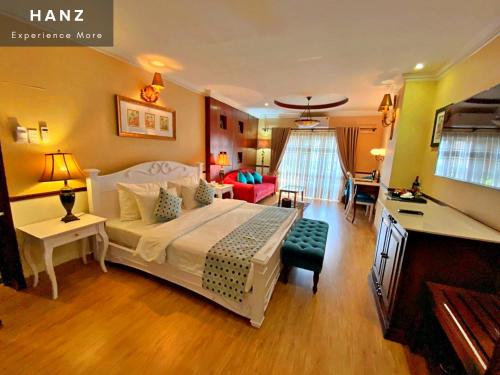 a bedroom with a large bed and a living room at HANZ Hoa Huong Duong Hotel in Ho Chi Minh City