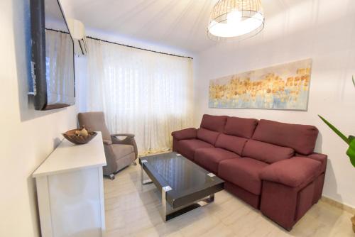 a living room with a couch and a table at New! Spacious & River in Seville