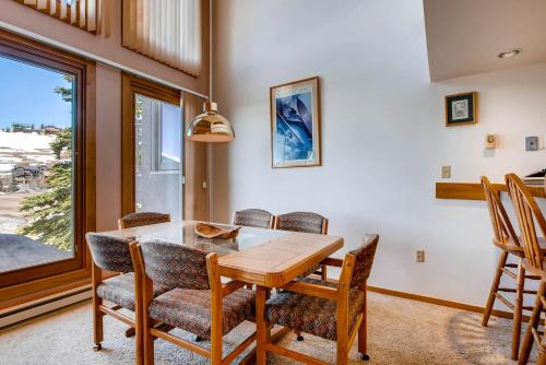 a dining room with a table and chairs and a window at The Plaza Condominiums by Crested Butte Mountain Resort in Mount Crested Butte