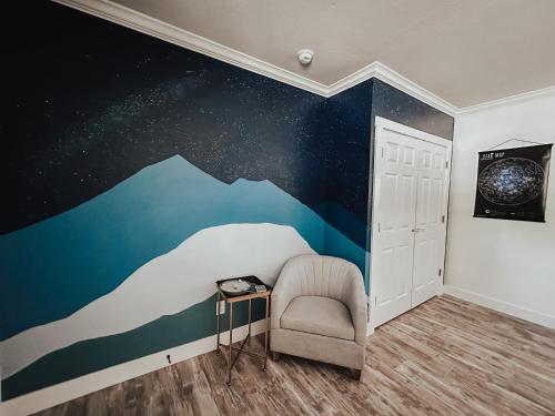 a bedroom with a wave mural on the wall at Woody Mountain Bed & Breakfast in Flagstaff