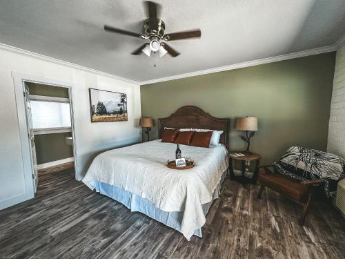 a bedroom with a bed and a ceiling fan at Woody Mountain Bed & Breakfast in Flagstaff