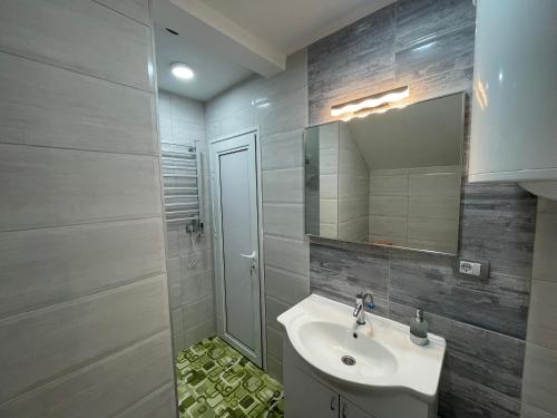 a bathroom with a sink and a mirror at Studio La Vista Sokobanja in Soko Banja