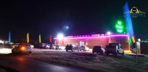 a group of cars parked in front of a building at night at NK Desert Camp Jaisalmer in Sām