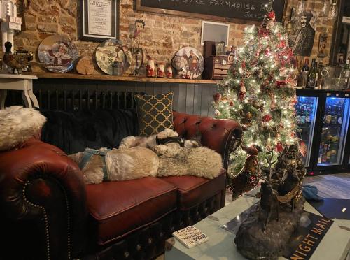 a living room with a christmas tree and a couch at The Foulsyke Licensed Bed and Breakfast Scalby Scarborough in Scarborough