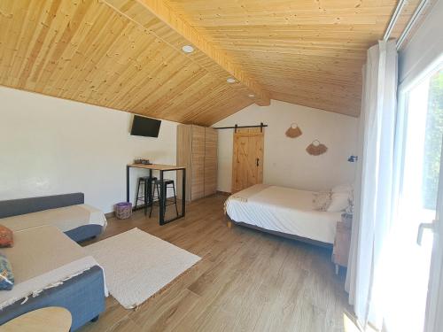 a living room with two beds and a window at Vila Louro in Santa Cruz