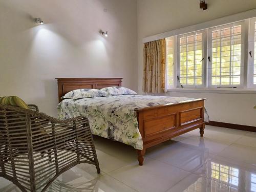 a bedroom with a bed and a bench in it at Boztreve Home in Kandy