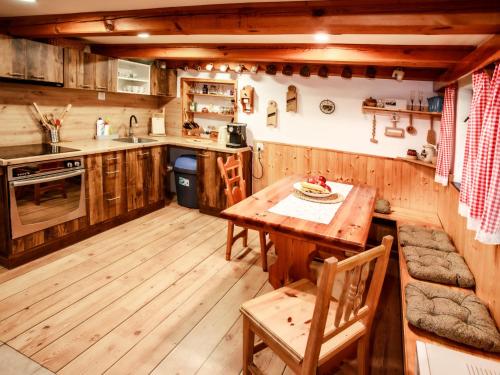 a kitchen with a wooden floor and a wooden table at Holiday Home Dolní Jílovice by Interhome in Vyšší Brod
