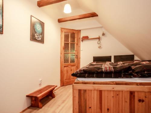 a bedroom with a bed and a wooden floor at Holiday Home Dolní Jílovice by Interhome in Vyšší Brod
