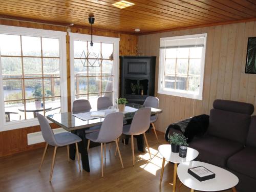 a living room with a table and chairs and a couch at Holiday Home Utsikt - SOW148 by Interhome in Fossdal