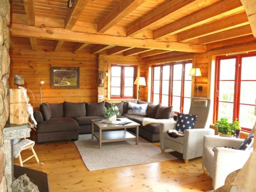 a living room with couches and a table at Chalet Lindefjeldbu - SOW144 by Interhome in Fossdal