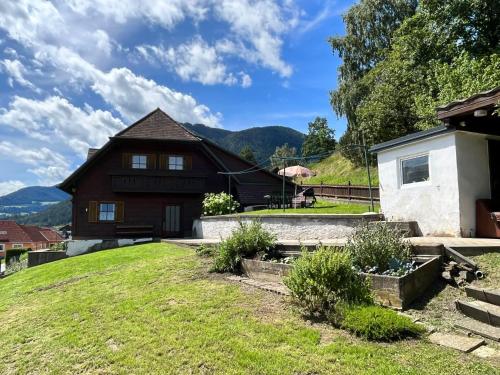 a house on a hill with a green yard at Holiday Home Lama by Interhome in Niederwölz