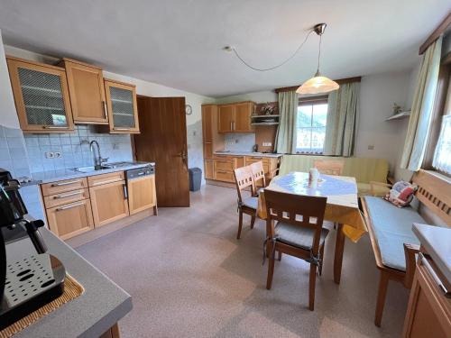 a kitchen with a table and chairs in a room at Holiday Home Lama by Interhome in Niederwölz
