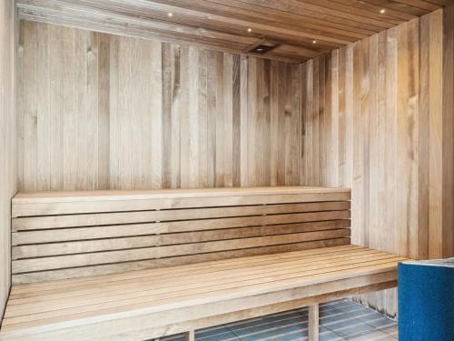 a sauna with a wooden bench in a room at Holiday Home Ronia - 900m from the sea in Lolland- Falster and Mon by Interhome in Bøtø By