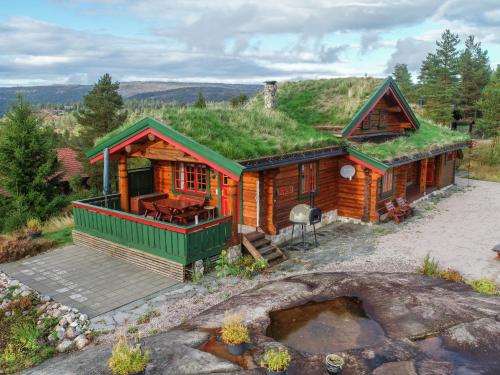 a log cabin with a grass roof at Chalet Kakebu by Interhome in Gjerstad