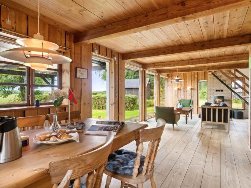 una cucina e una sala da pranzo con soffitto in legno di Holiday Home Thana - 8km from the sea in Bornholm by Interhome a Gudhjem